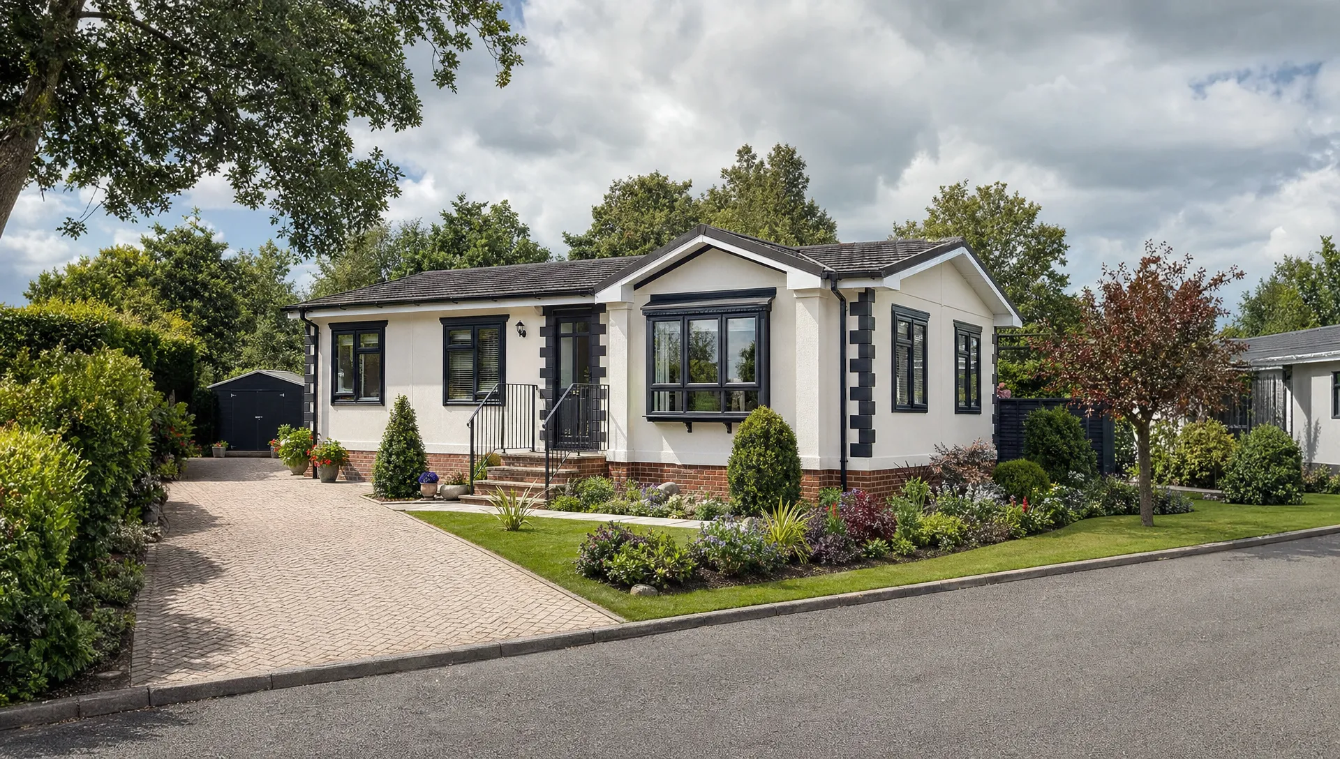 A detached luxury park home bungalow beside a quiet lane, with a private driveway, neat garden and landscaped grounds, showing the home to check when budgeting for park home council tax.